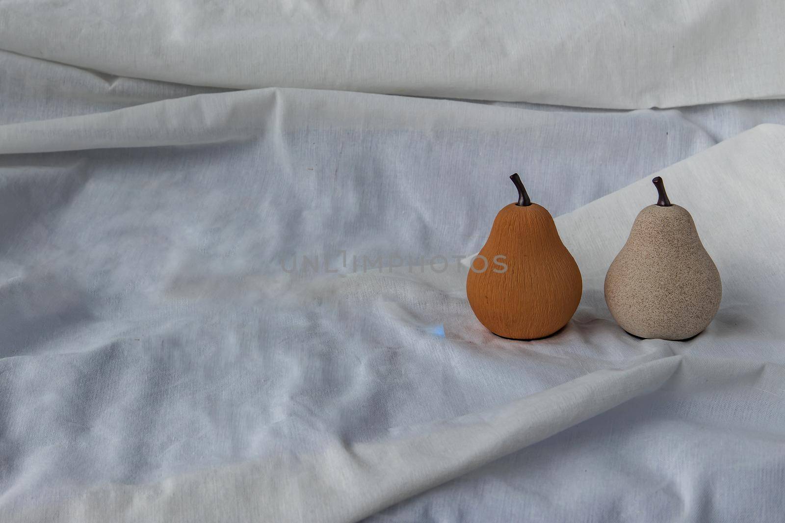 Two ceramics pear fruits on white background. Ceramic tableware, Home decor, Copy space, No focus, specifically.