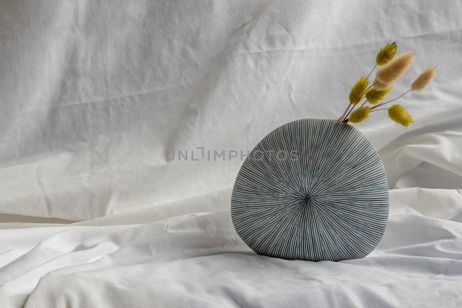 Dried flowers in Handmade Ceramic Vase on White background. Home decor, Space for text.