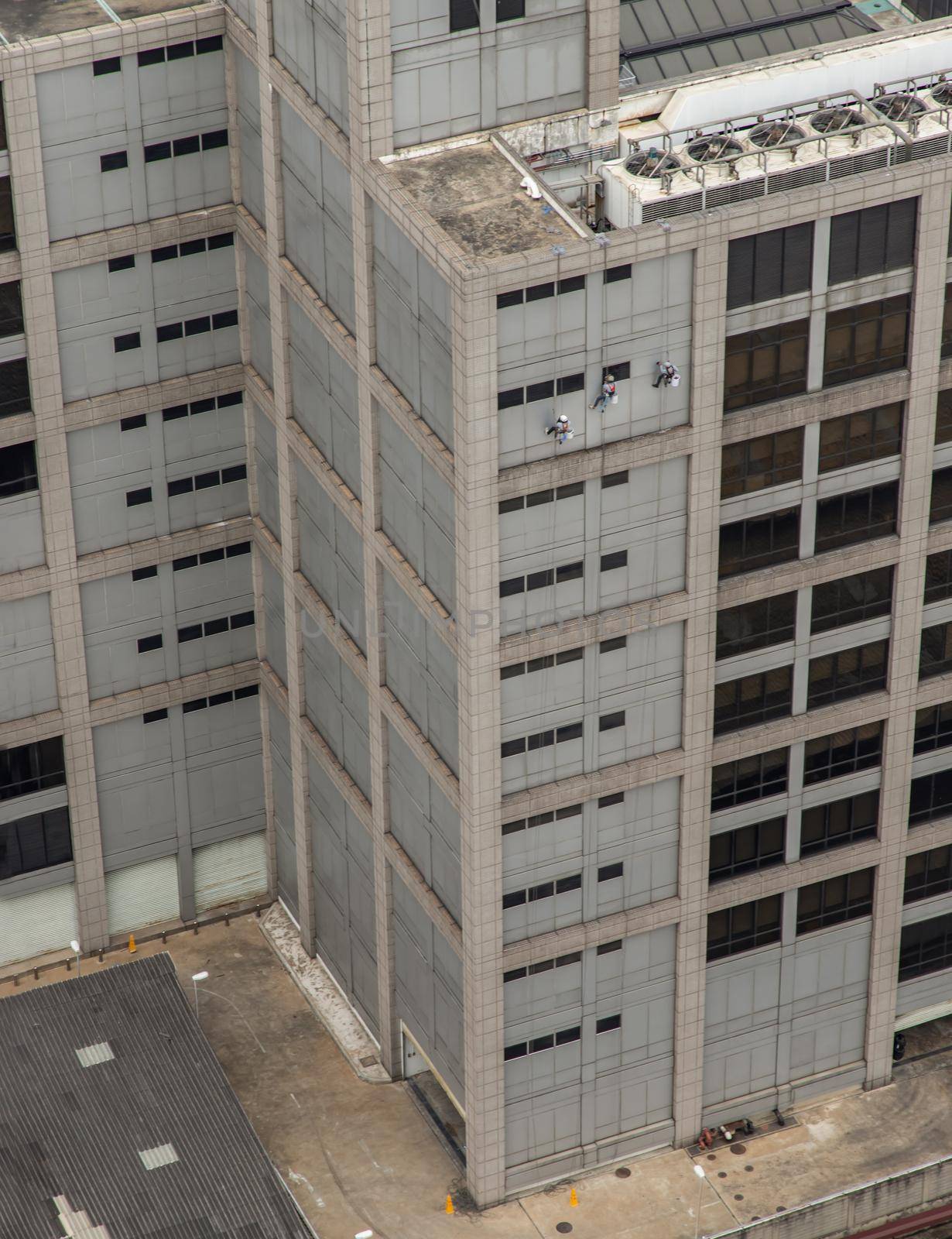 Group of workers cleaning windows service on high rise office building. Selective focus.