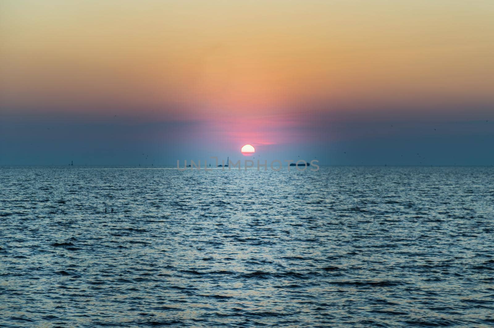 Beautiful​ Sunset​ Sky​ above​ the ocean​ with reflection. Selective focus.