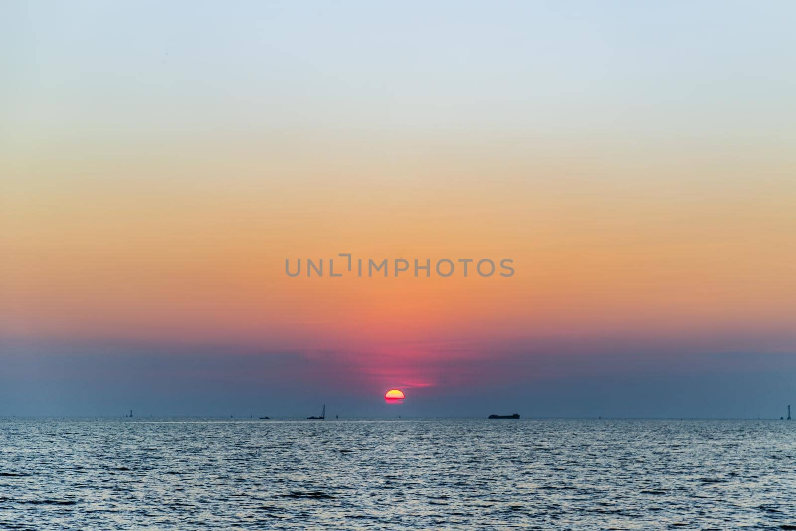 Beautiful​ Sunset​ Sky​ above​ the ocean​ with reflection. Selective focus.