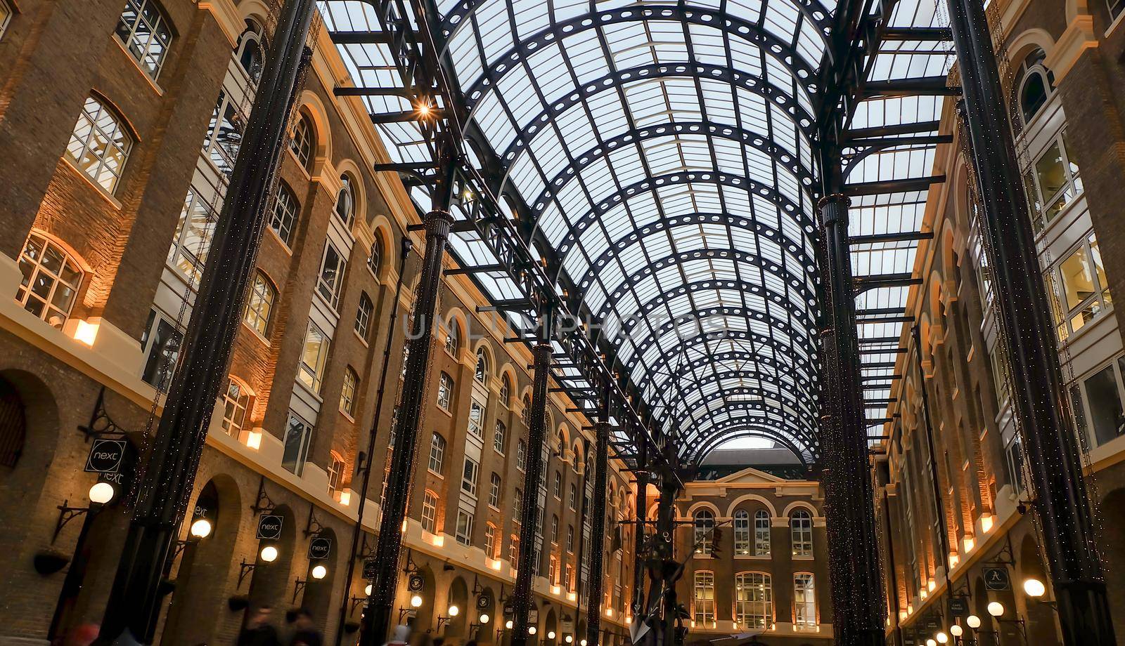 London, England - Apr 20, 2019 : Interior view of Hay's Galleria glass roof. Is a mixed use building in the London Borough of Southwark, featuring offices, restaurants, shops, and flats. No focus, specifically.