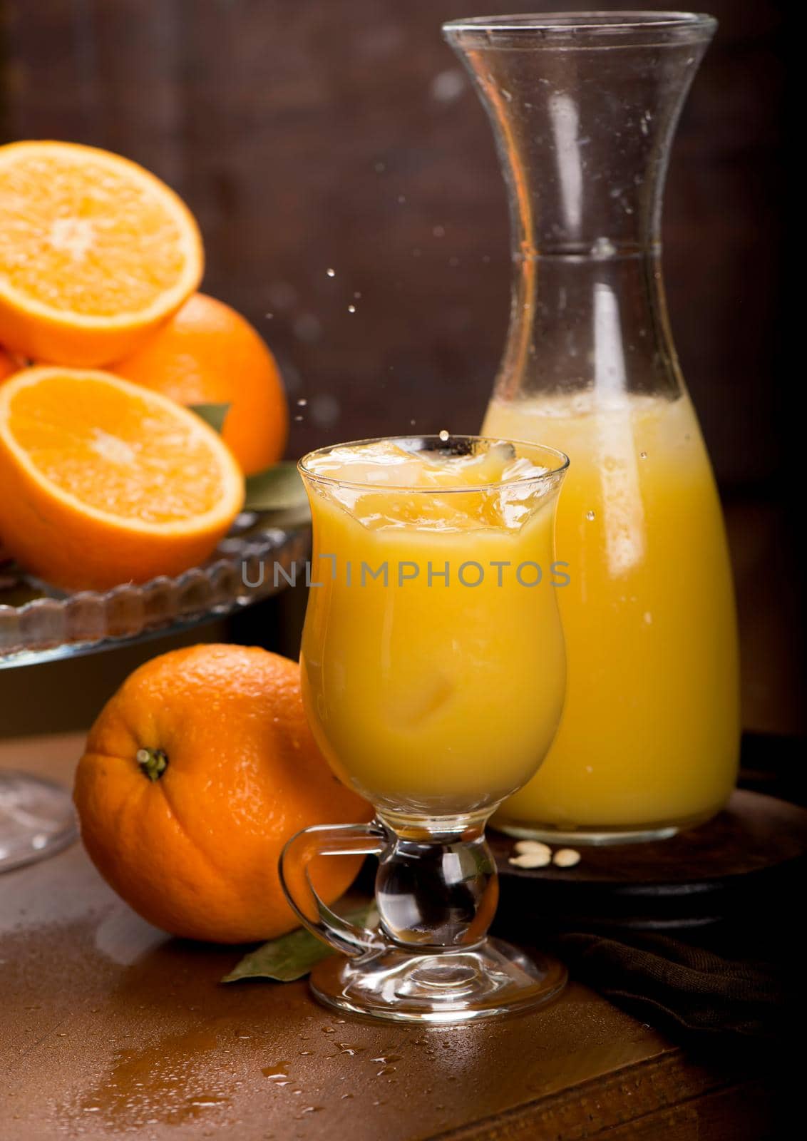 glass of fresh orange juice with fresh fruits on wooden table