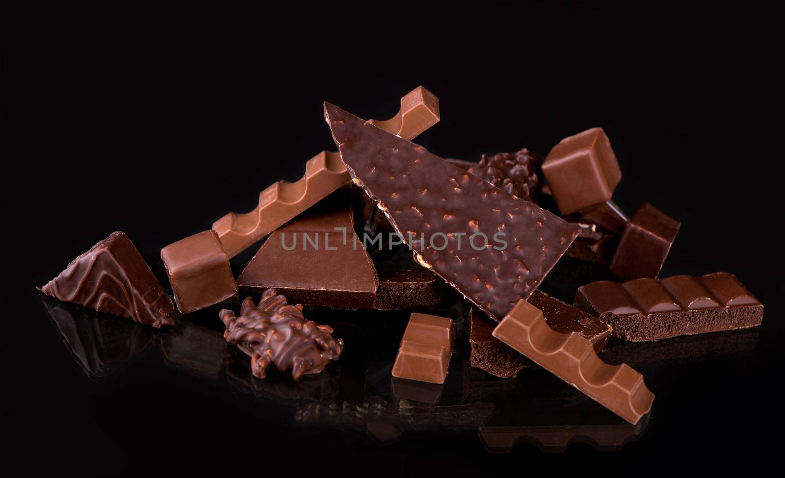 chocolate pieces and cocoa powder on wooden background by aprilphoto