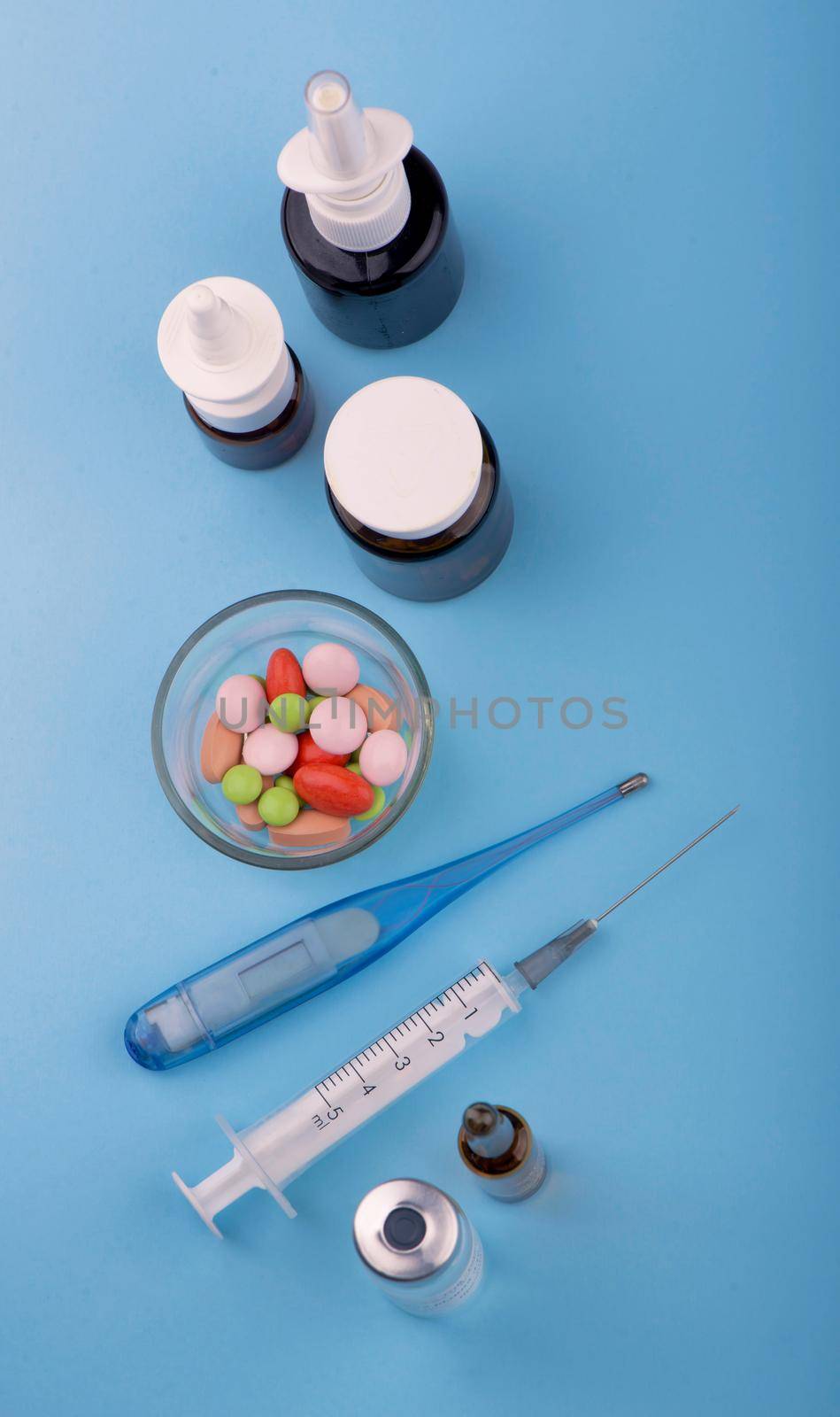 syringe and pills are on the table, medical supplies are on the table.