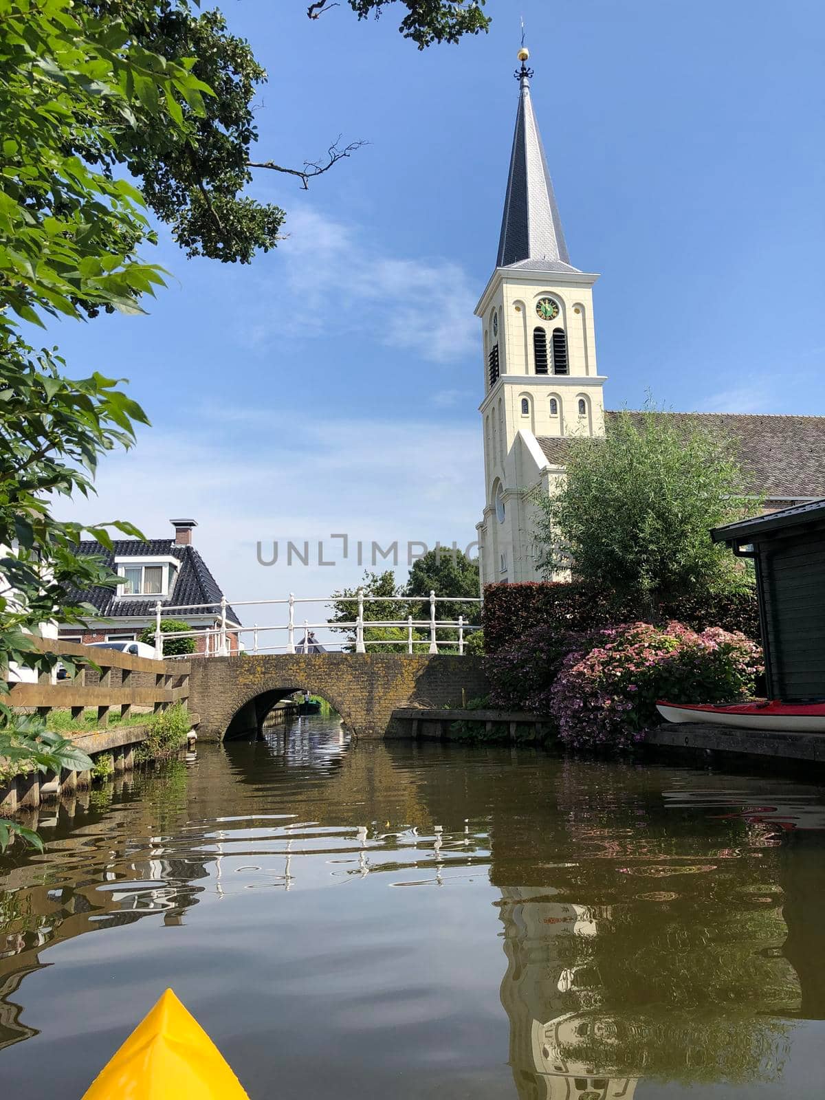 Canoeing through the town oosthem in Friesland, The Netherlands