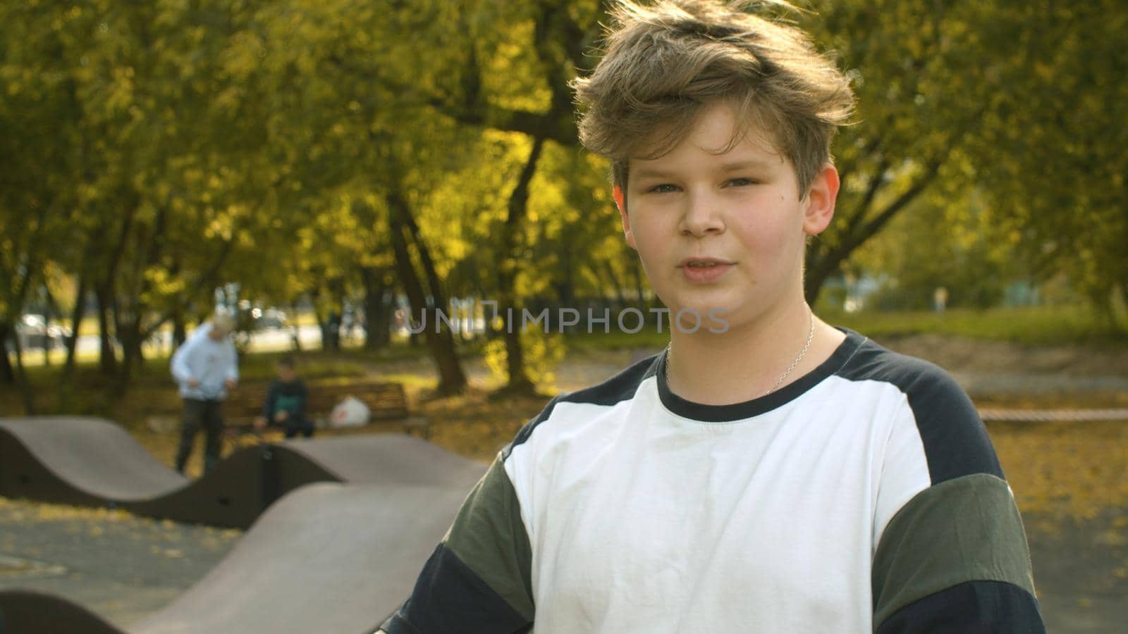 Portrait of the boy on the background of the park near pump track. Childrens sport and healthy lifestyle concept