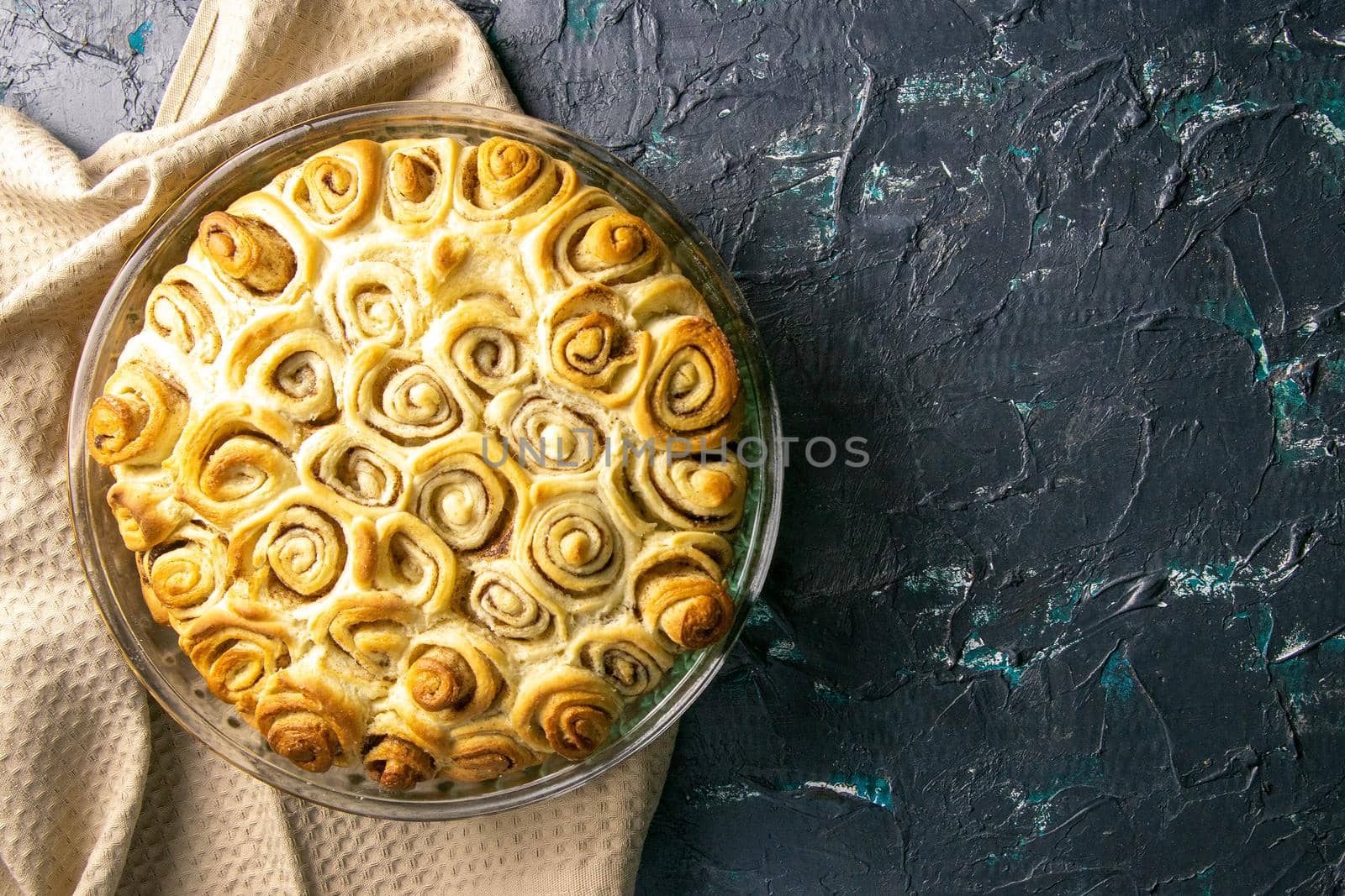 Apple pie with cinnamon on retro wooden background. Top views with clear space.