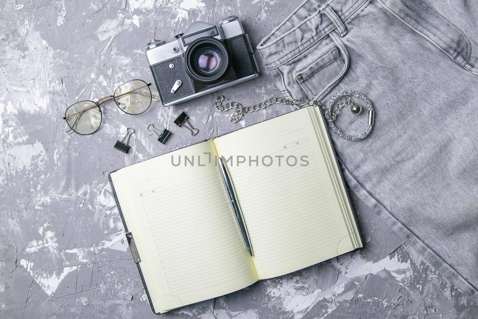 Business concept - Top view of stationery like open notebook, pencil ... etc for mockup design on gray marable table with copy space.