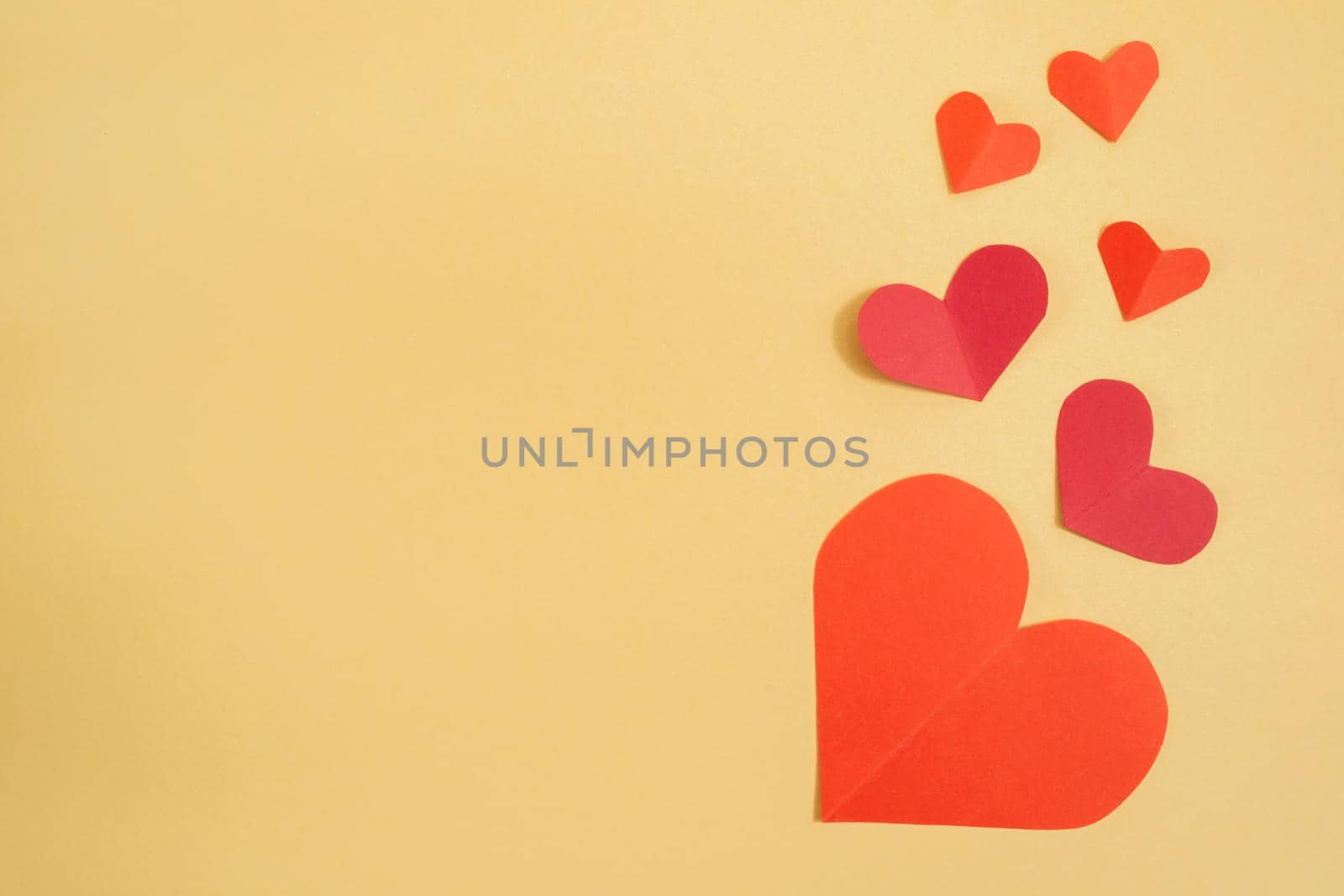 Valentine's Day background. Pink and red hearts on a pastel yellow background. Valentine's Day concept. Flat lay, top view, copy space by Alla_Morozova93