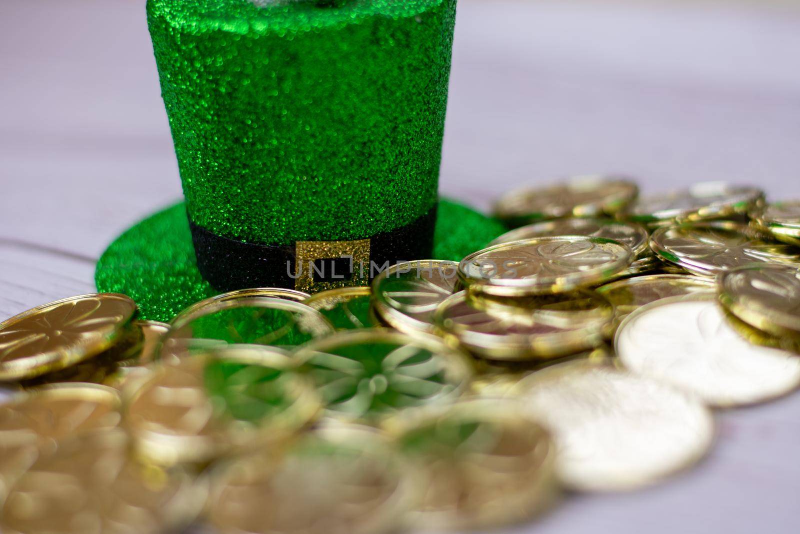 A Glitter Covered Saint Pattys Day Hat With Gold Coins in Front of It by bju12290