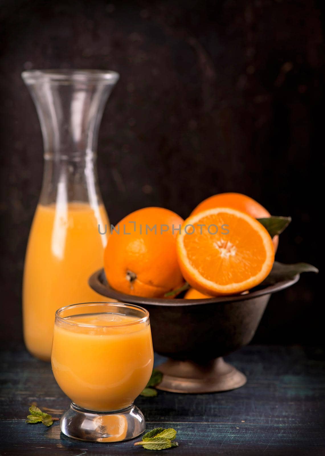 glass of fresh orange juice with fresh fruits on wooden by aprilphoto