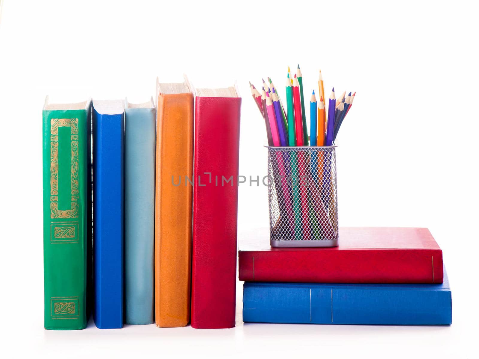 stack of Old books and color pencils isolated on white by aprilphoto