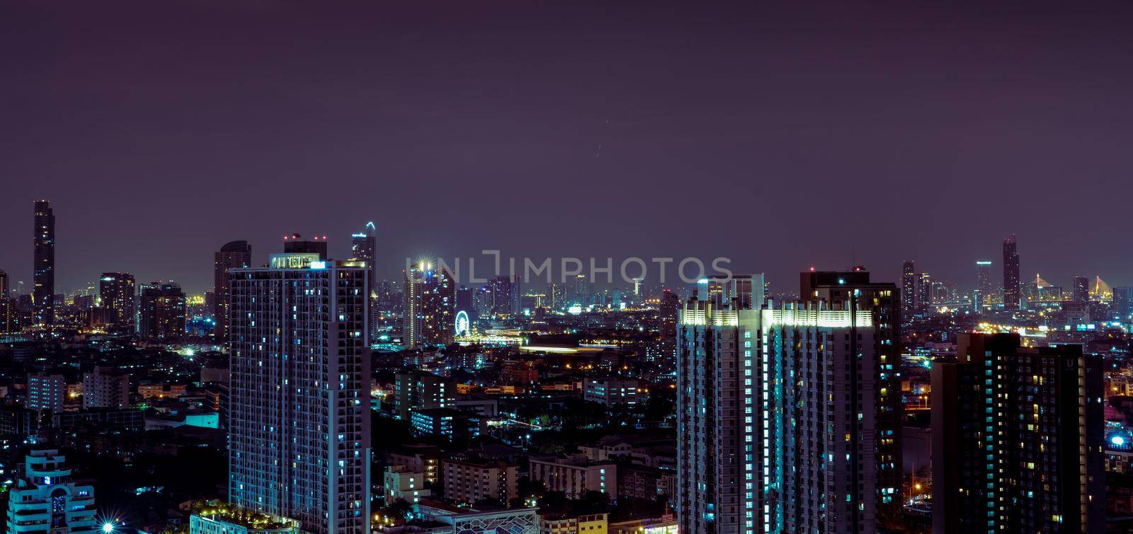 Cityscape of modern building in the night. Modern architecture office building. Skyscraper with beautiful evening sky. Business and financial center building. Apartment in the city with night light. by Fahroni
