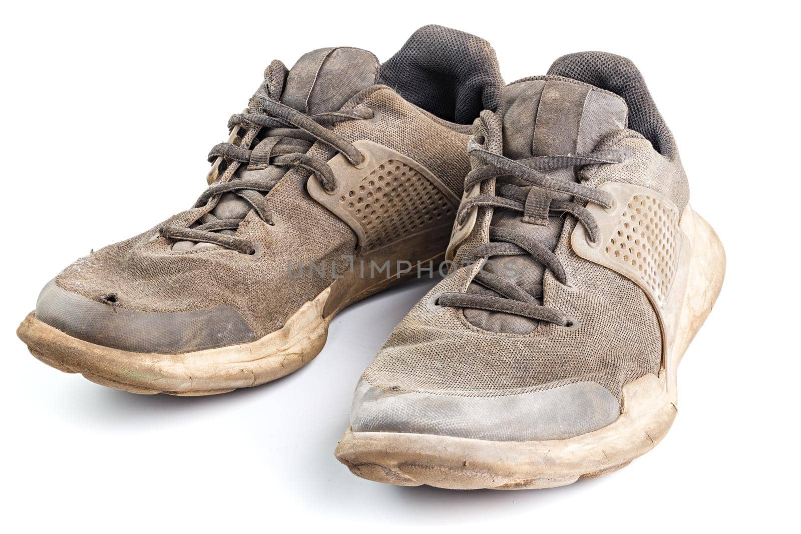 a pair of weared dirty sneakers isolated on white background, edge-to-edge sharpness