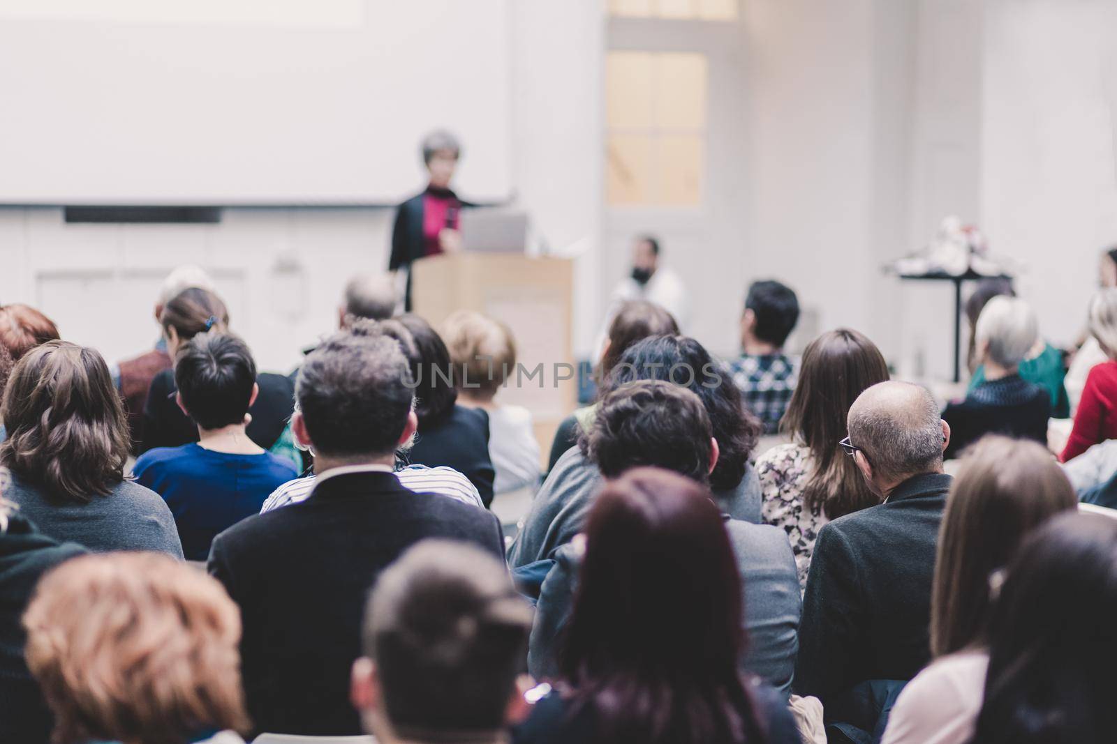 Woman giving presentation on business conference. by kasto