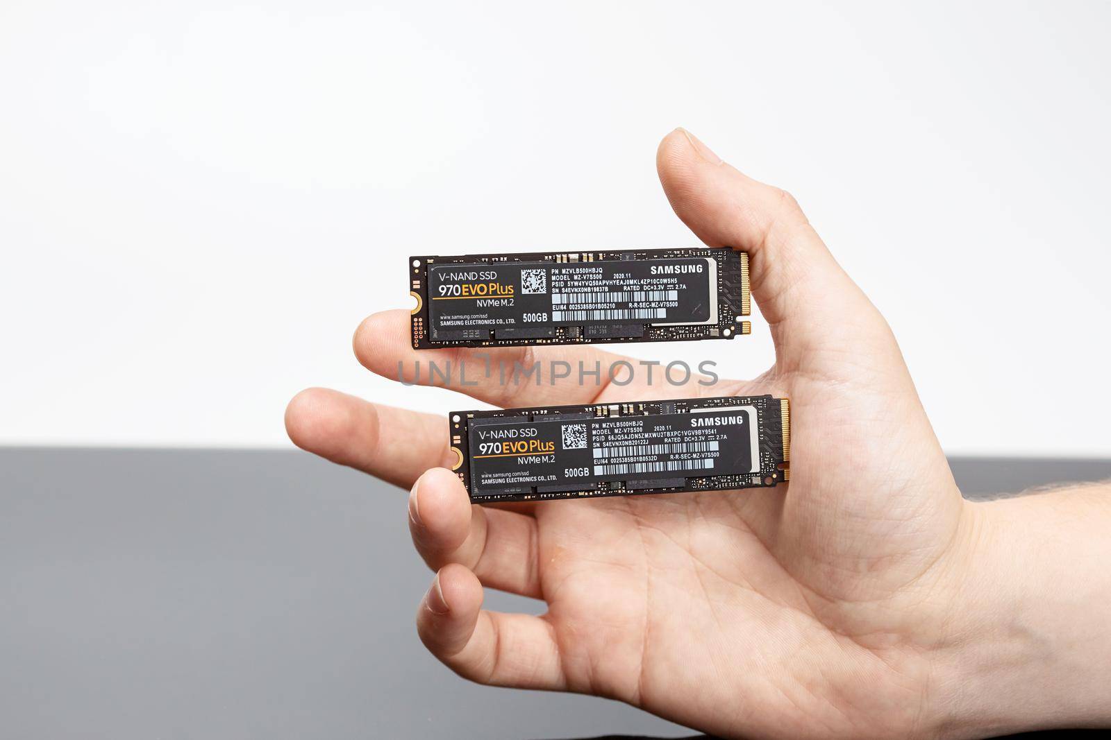 Moscow, Russia -25 Dec 2020: Two dice of ssd hard drive in a man's hand.