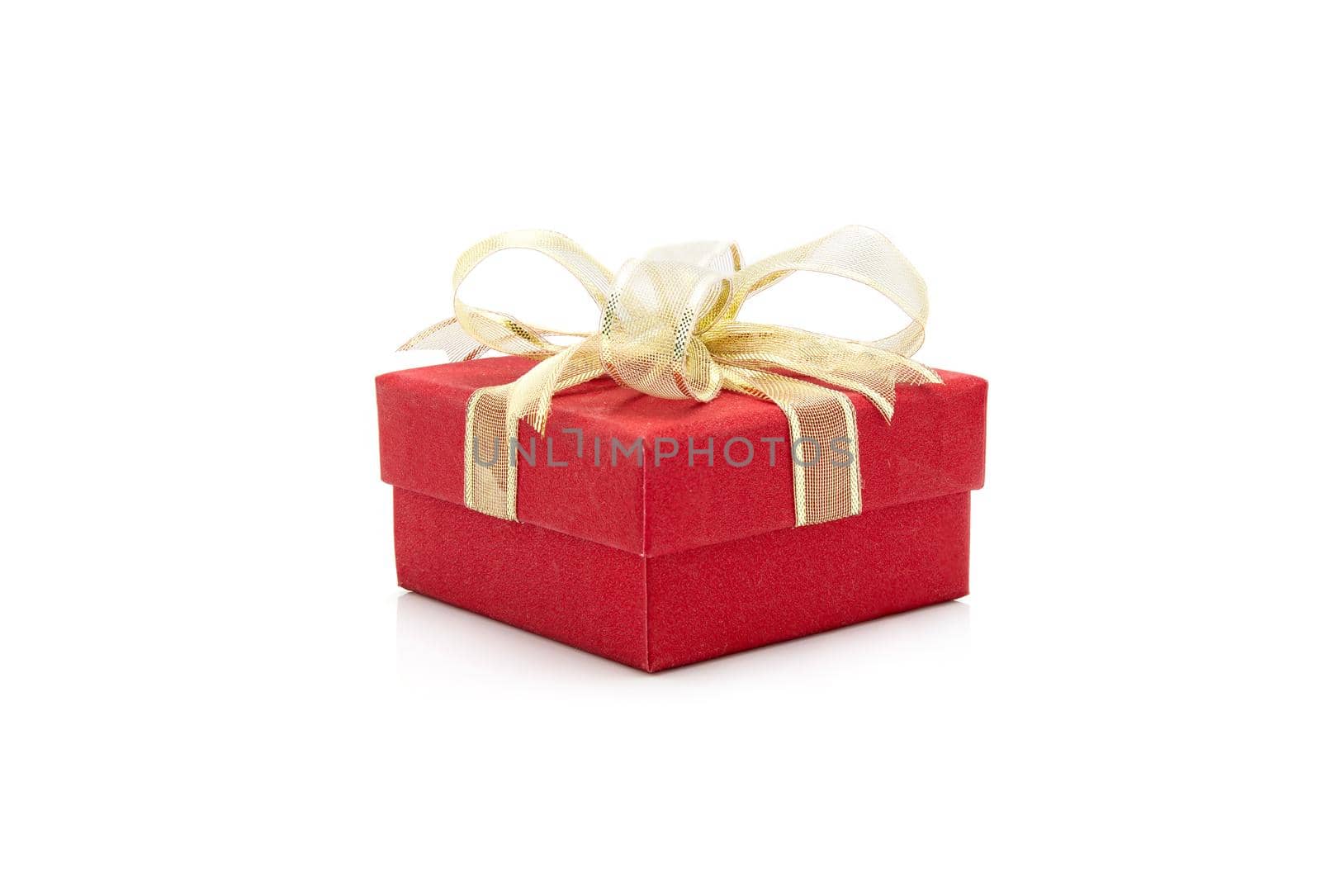 Red gift box and ribbon  isolated on white background, presents in valentine day or Christmas day, object in birthday or anniversary, package with wrap luxury, nobody, holiday and festive concept.