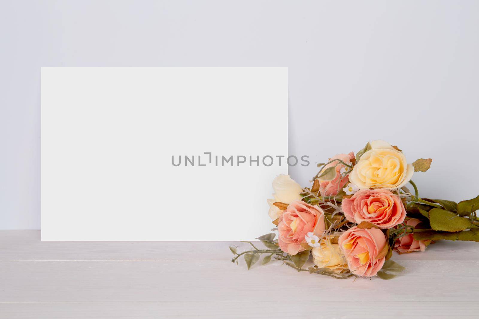 Valentine day, greeting card mockup empty and flower on wooden table, postcard blank with romance on desk, present in anniversary and celebration, paper for message with vertical, holiday concept. by nnudoo