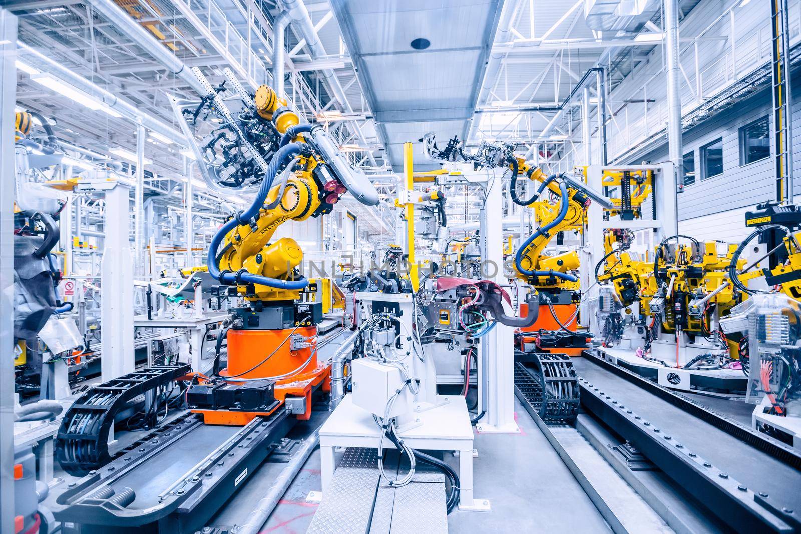 robotic arms in a car plant