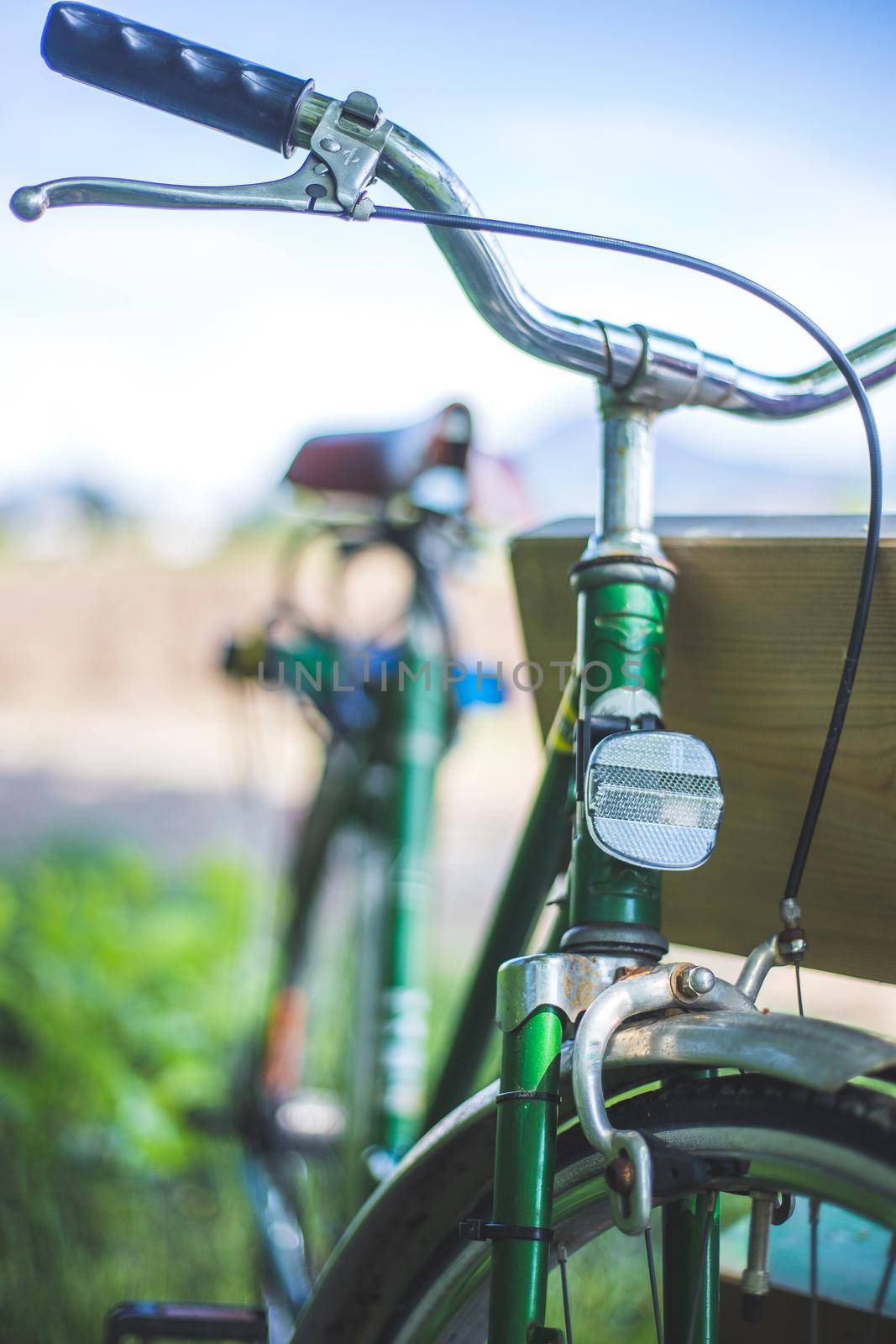 Front picture of a vintage retro bike, head reflectors and blurry background