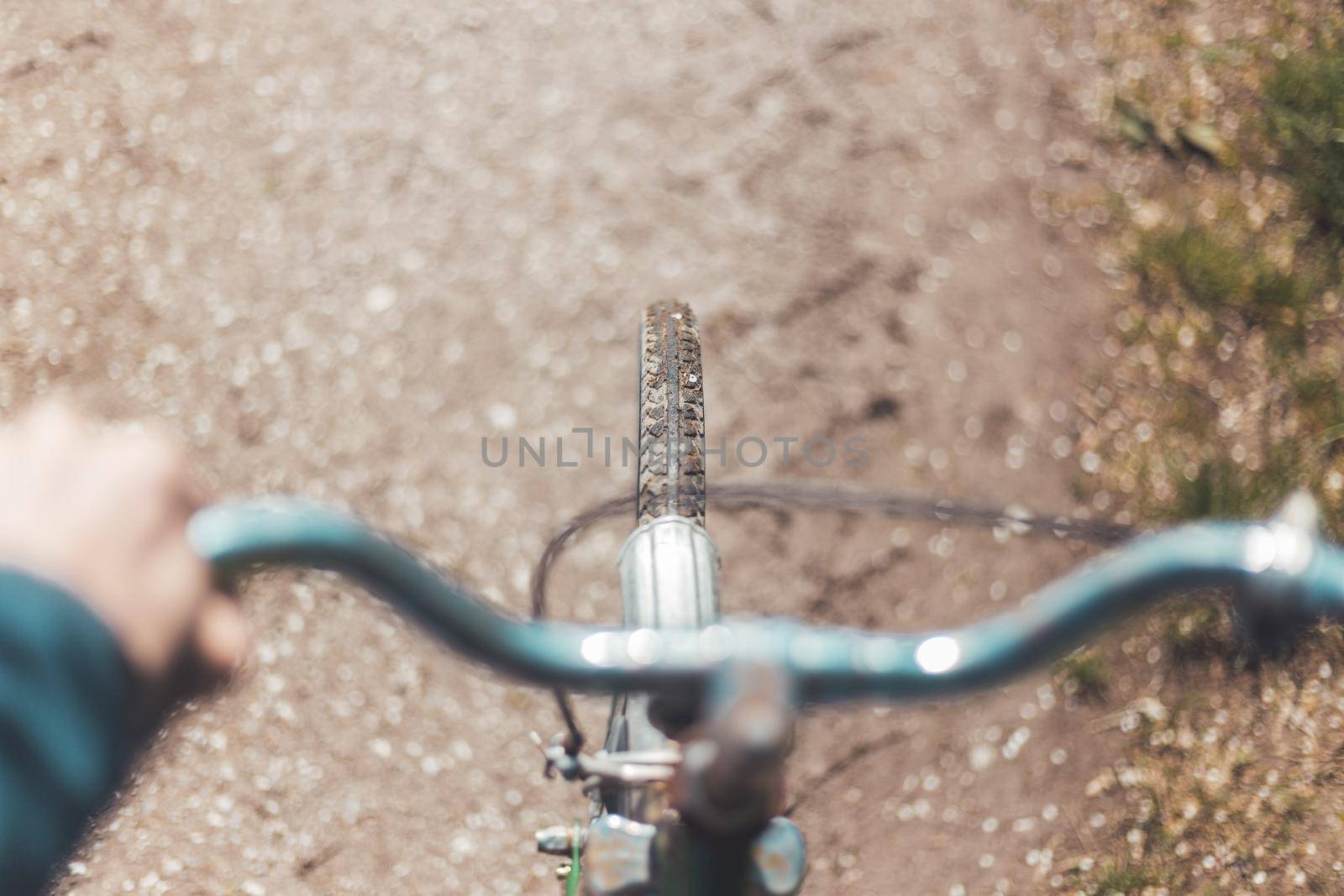 Close up picture of retro bike tire, blurry handlebar, summer day