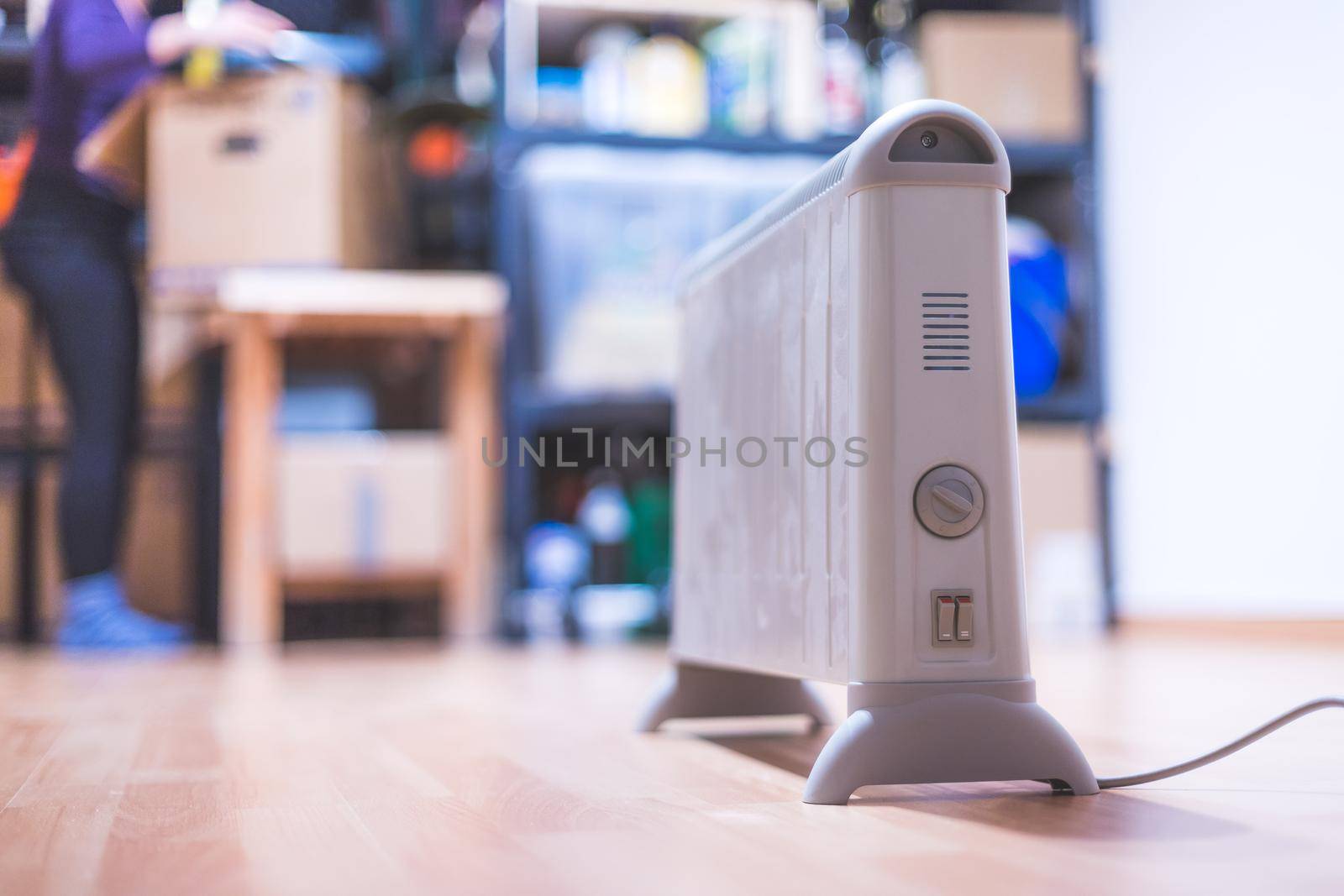 Electric heater, heating the basement. Blurry shelfs in the background