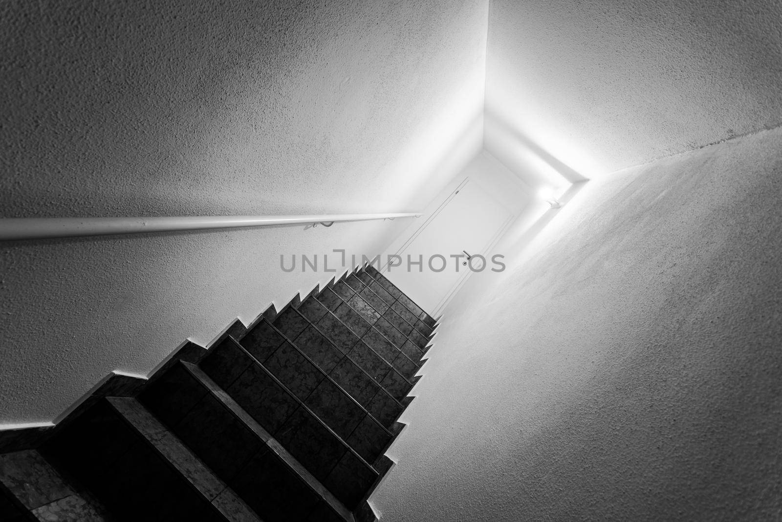 Basement stairs with balustrade, closed white door