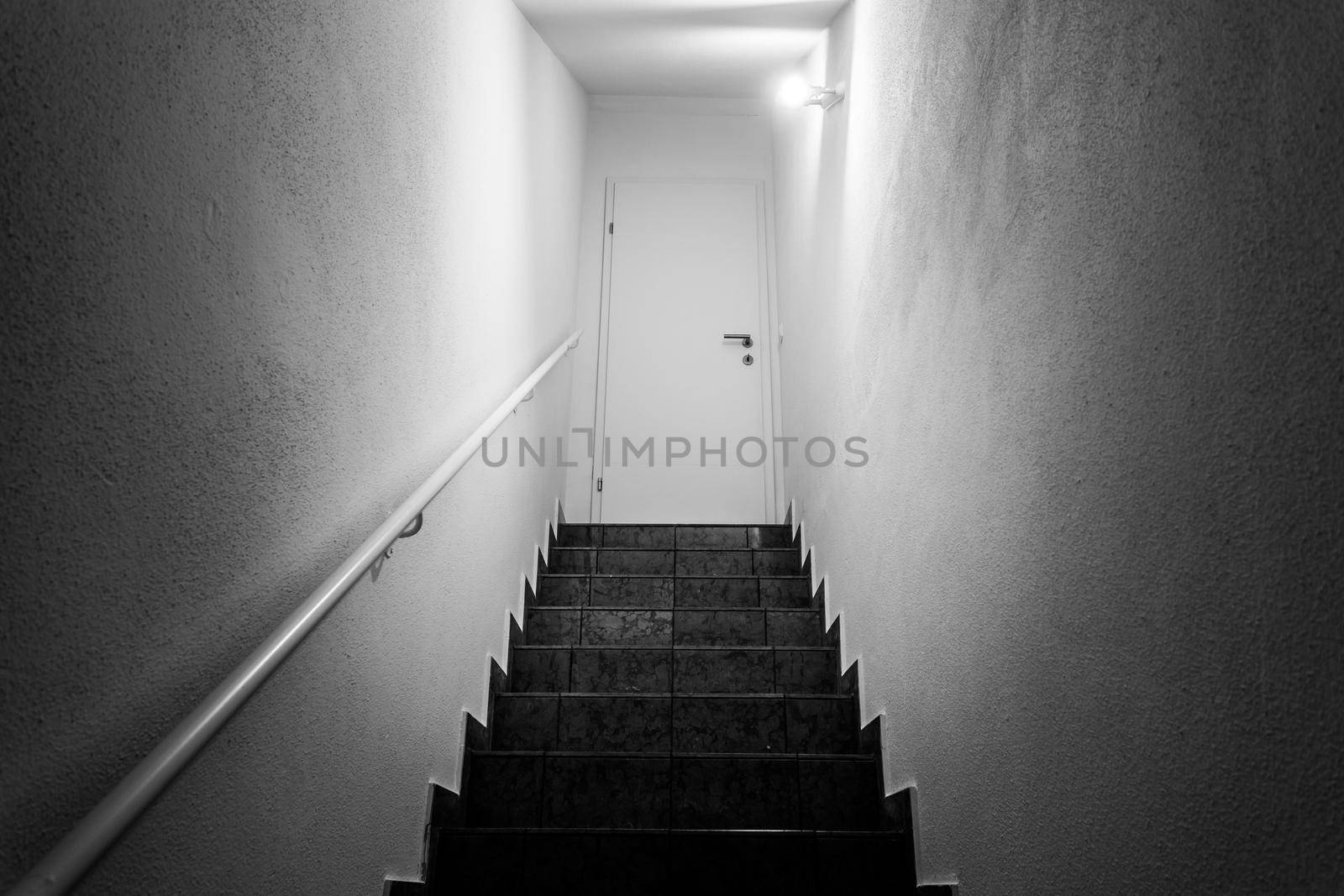 Basement stairs with balustrade, closed white door