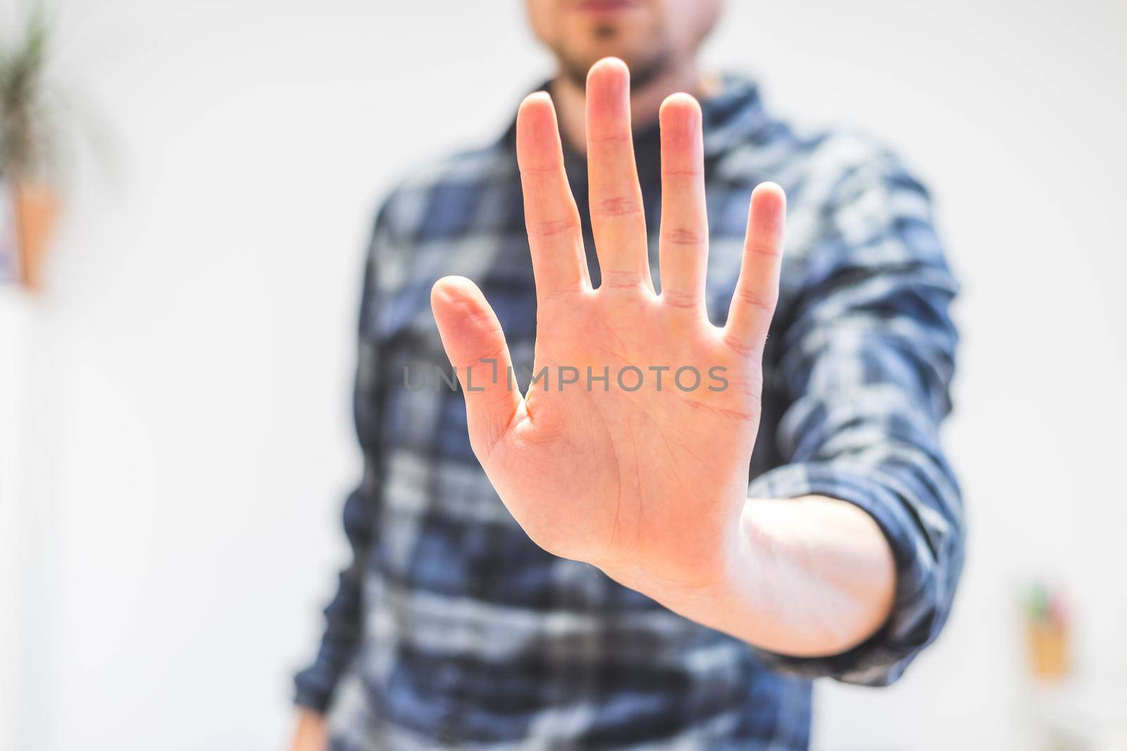 Man showing stop gesture, close up of the hand