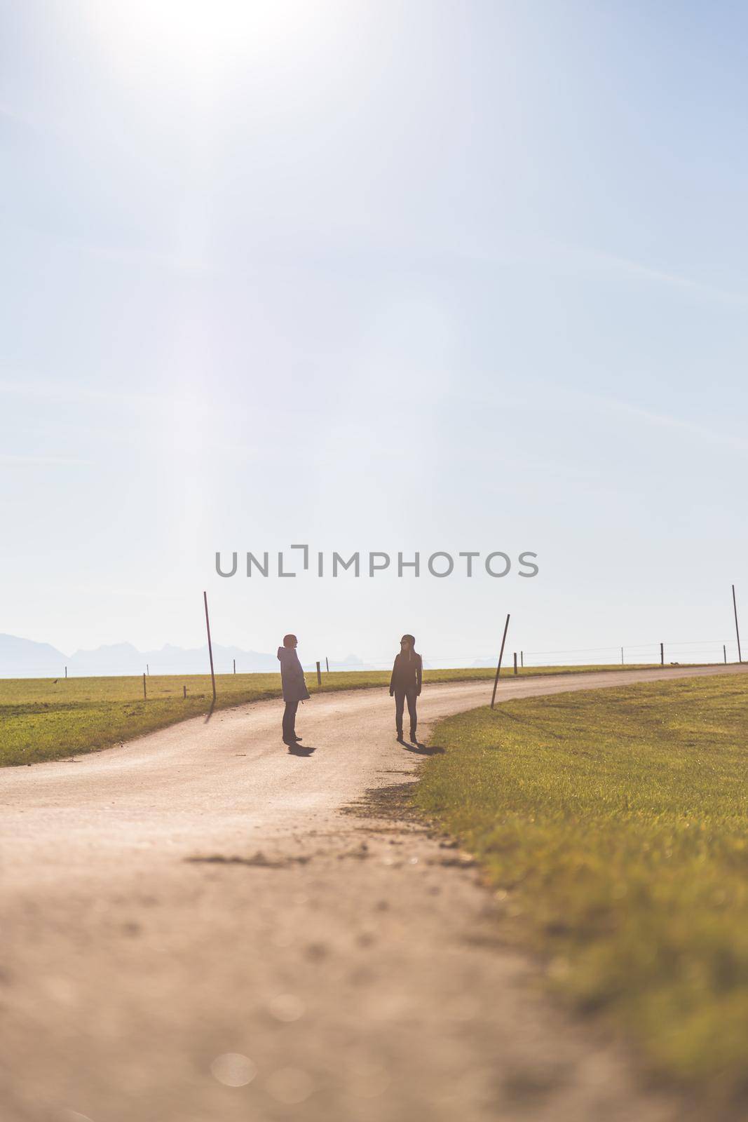 Two people are walking on an abandoned road