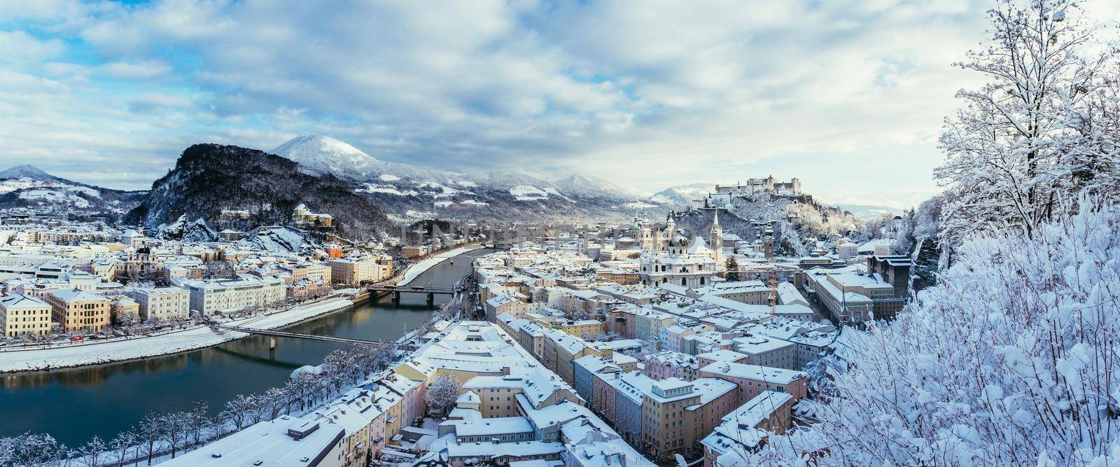 Panorama of Salzburg in winter: Snowy historical center, sunshine by Daxenbichler