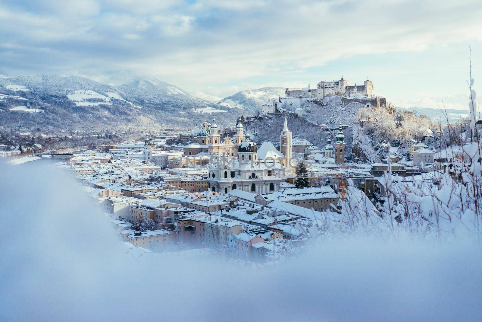 Panorama of Salzburg in winter: Snowy historical center, sunshine