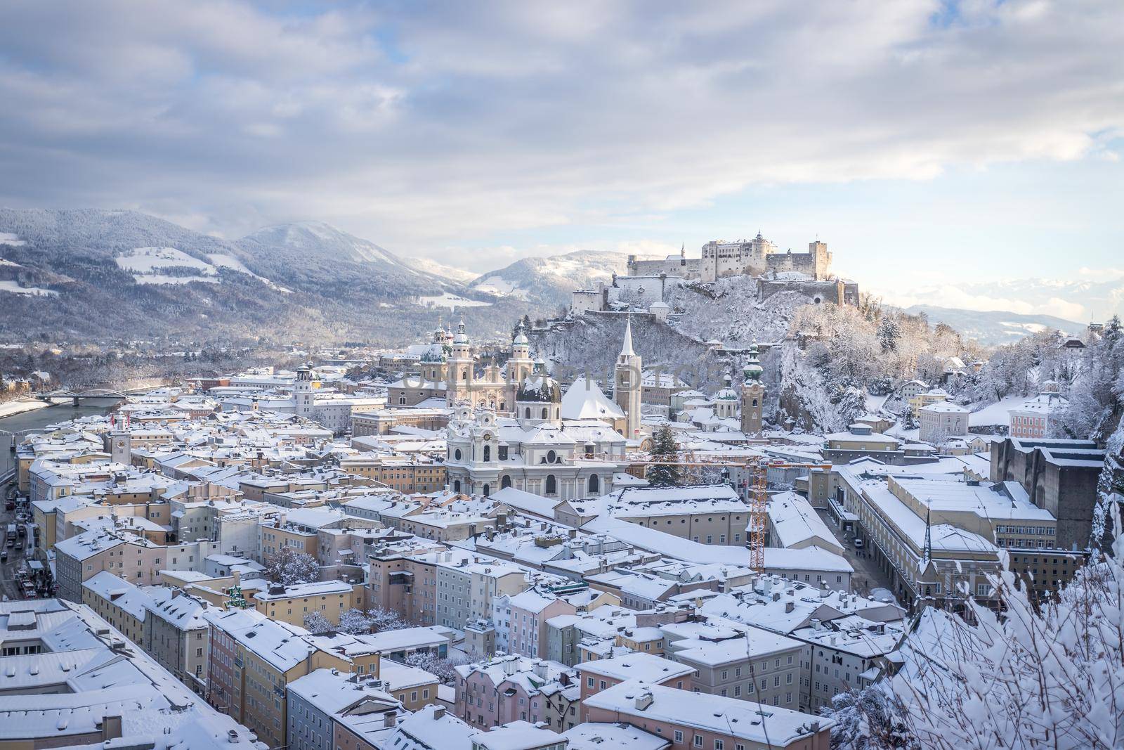 Panorama of Salzburg in winter: Snowy historical center, sunshine