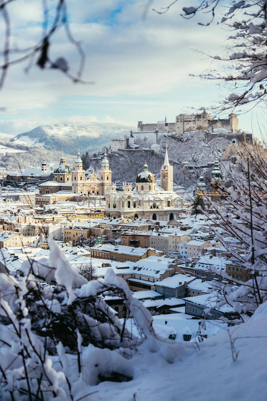 Panorama of Salzburg in winter: Snowy historical center, sunshine