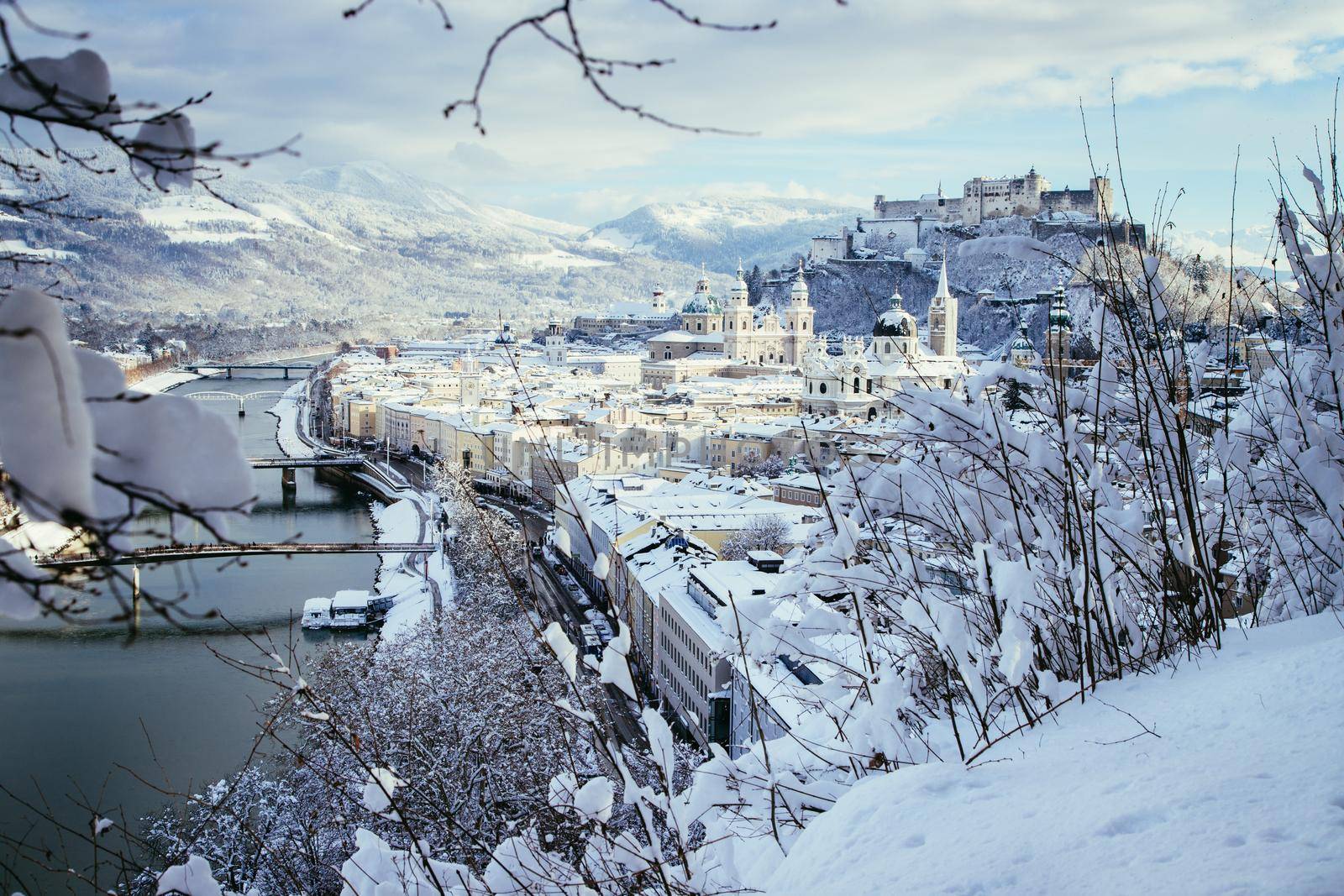 Panorama of Salzburg in winter: Snowy historical center, sunshine