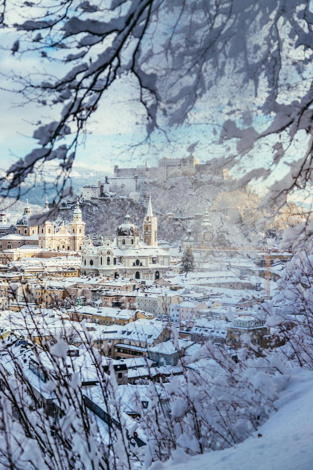 Panorama of Salzburg in winter: Snowy historical center, sunshine