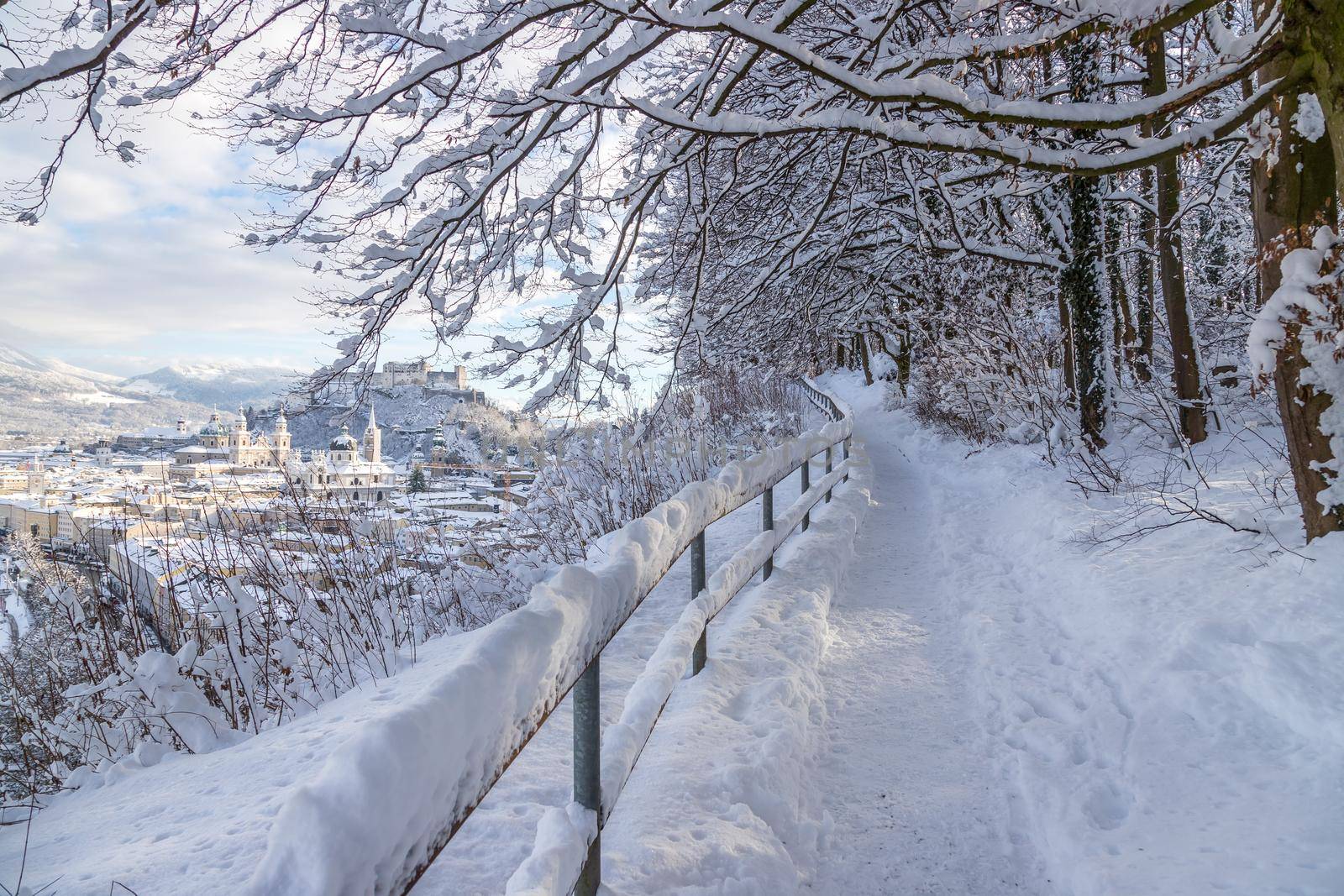 Walking promenade in Salzburg, snowy winter landscape