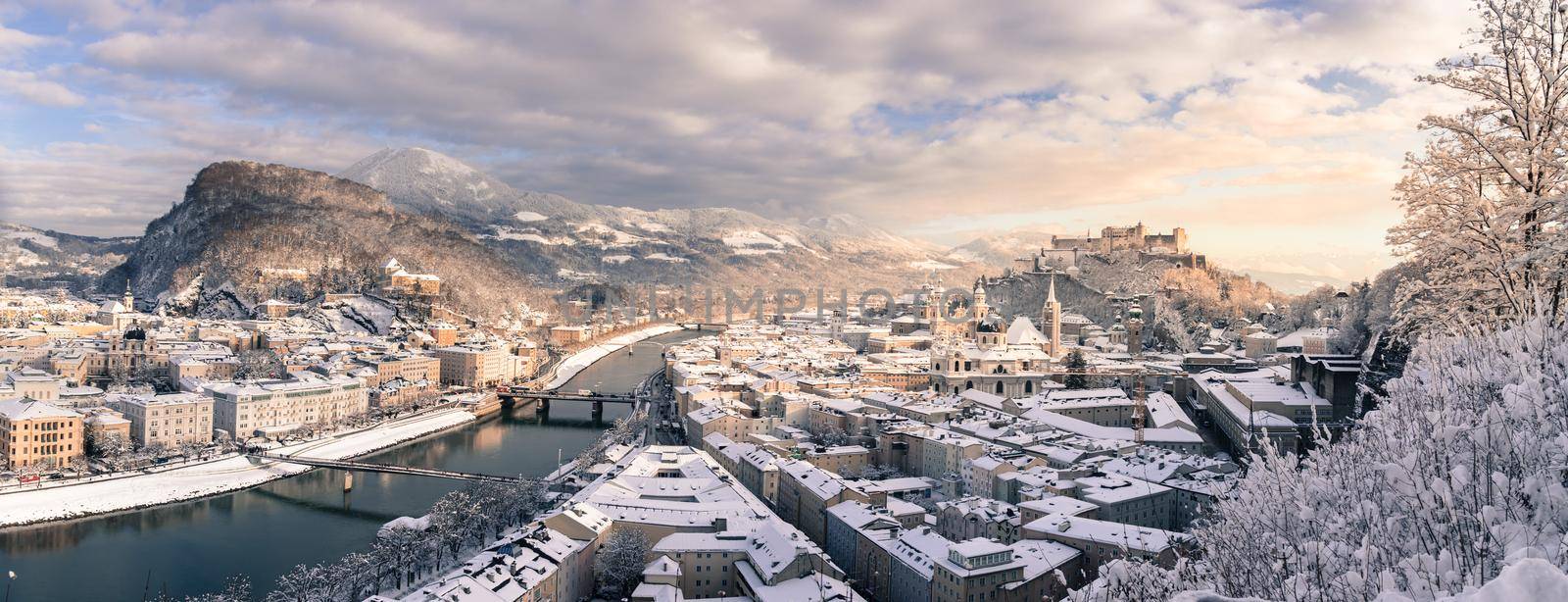 Panorama of Salzburg in winter: Snowy historical center, sunshine