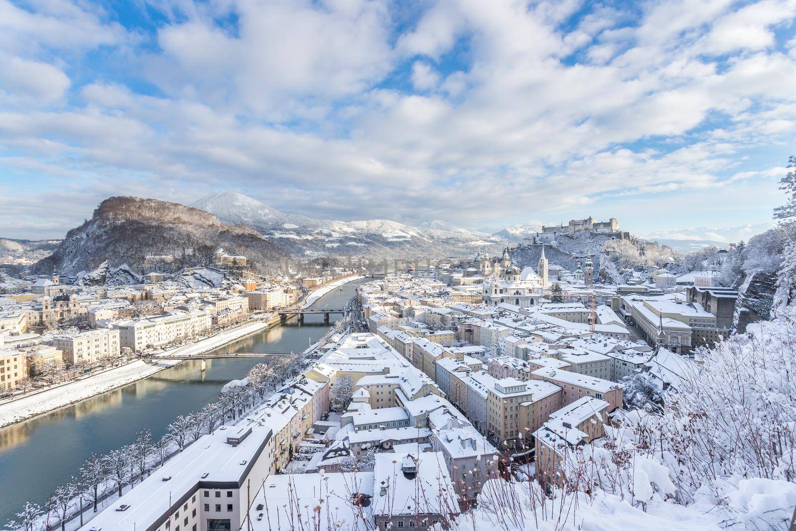 Panorama of Salzburg in winter: Snowy historical center, sunshine