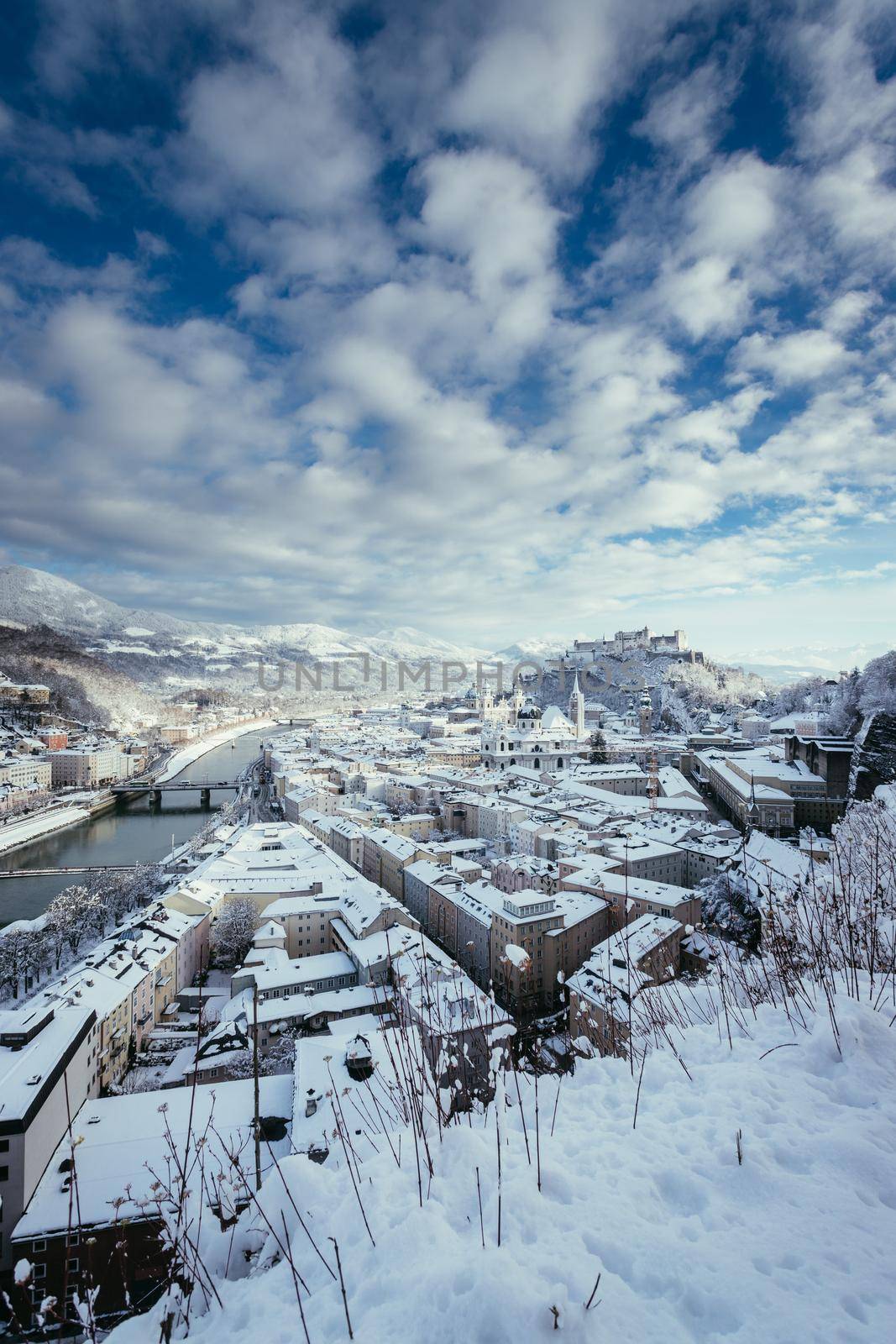 Panorama of Salzburg in winter: Snowy historical center, sunshine by Daxenbichler