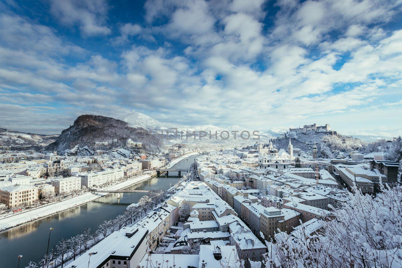 Panorama of Salzburg in winter: Snowy historical center, sunshine