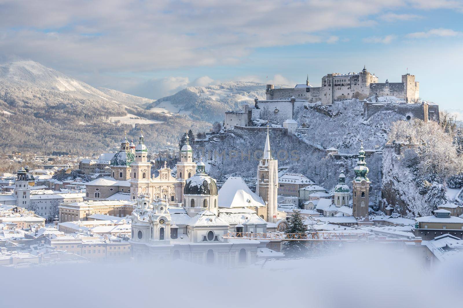 Panorama of Salzburg in winter: Snowy historical center, sunshine