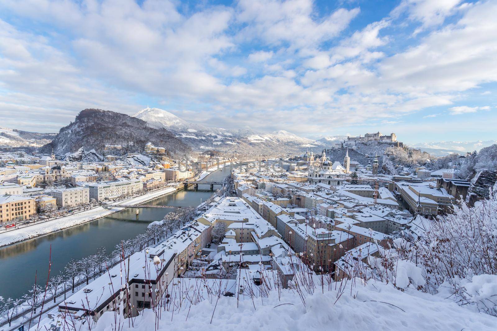 Panorama of Salzburg in winter: Snowy historical center, sunshine