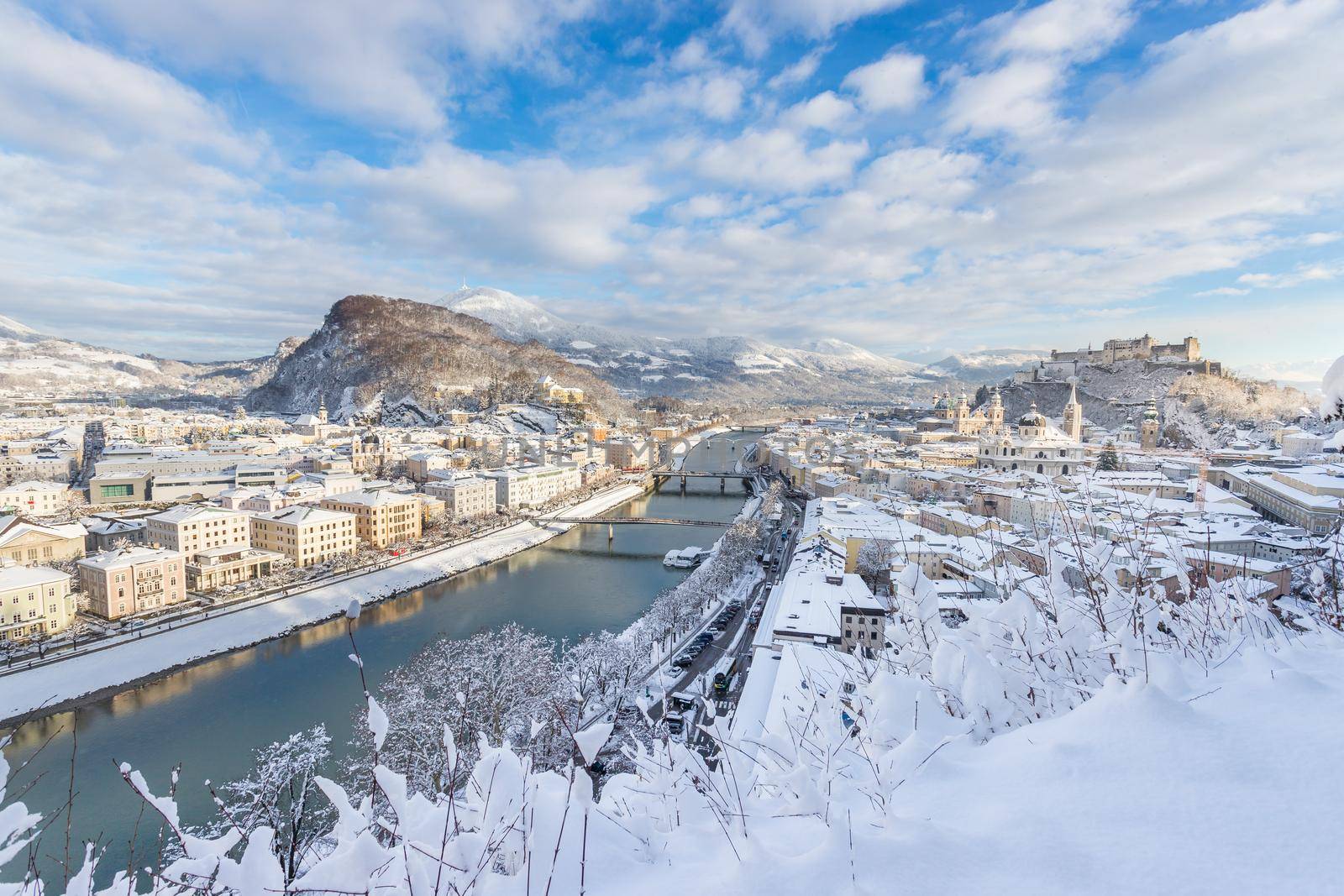 Panorama of Salzburg in winter: Snowy historical center, sunshine