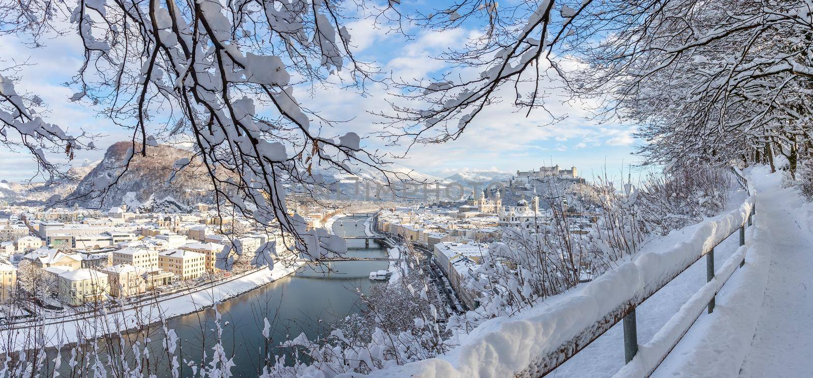 Panorama of Salzburg in winter: Snowy historical center, sunshine