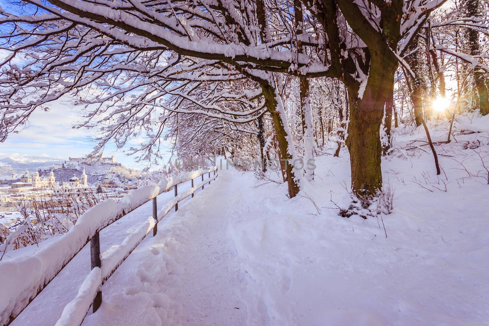 Walking promenade in Salzburg, snowy winter landscape