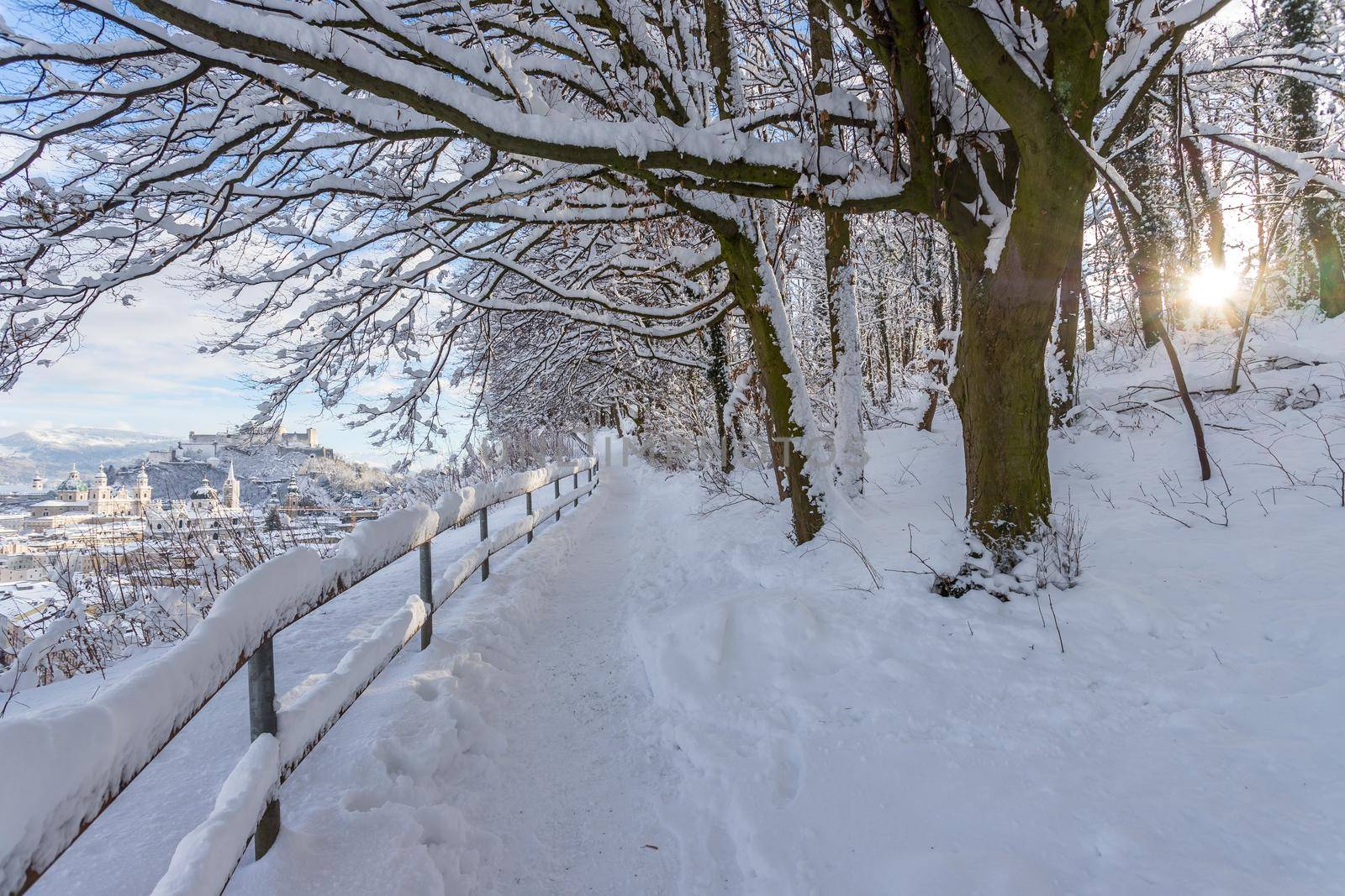 Walking promenade in Salzburg, snowy winter landscape