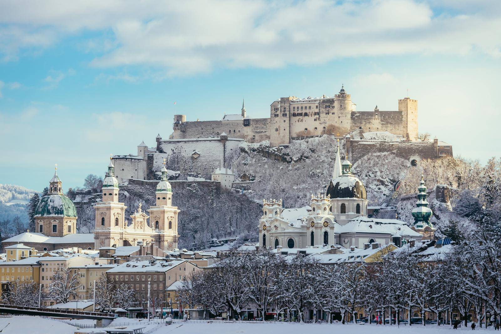 Panorama of Salzburg in winter: Snowy historical center, sunshine
