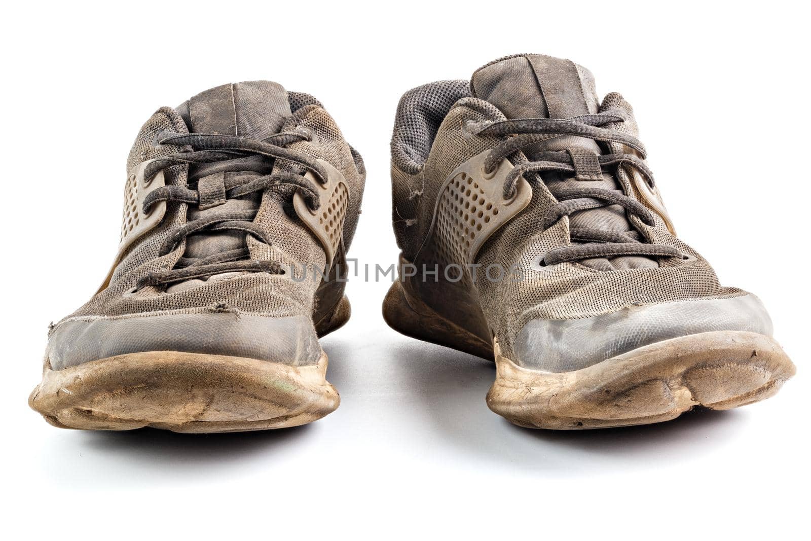 a pair of weared dirty sneakers isolated on white background, edge-to-edge sharpness, frontal vew